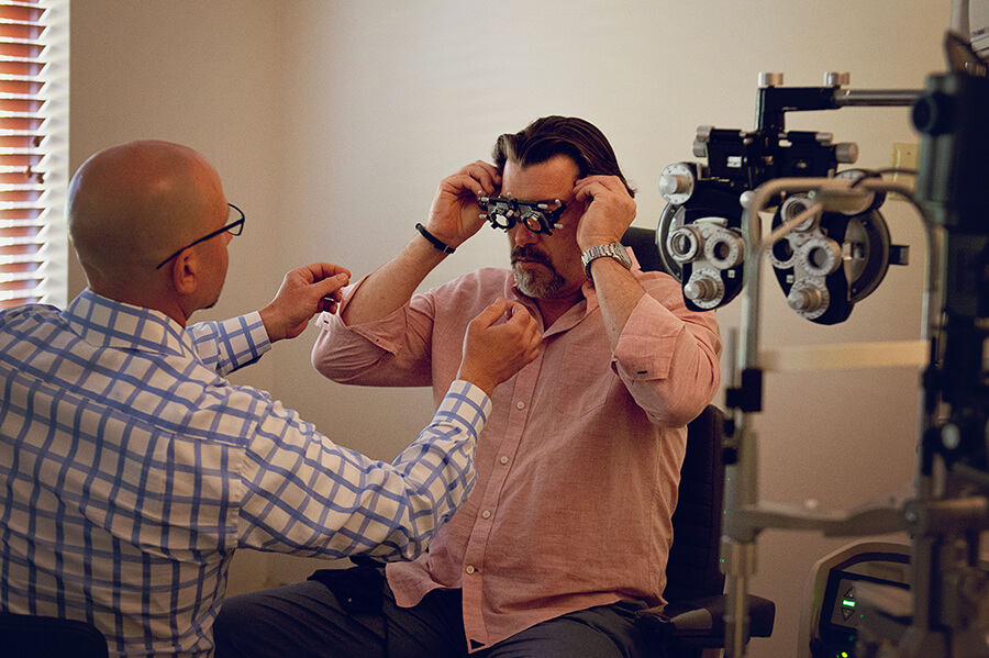 Dr. Sullivan Helping a Patient Setup for an Eye Exam